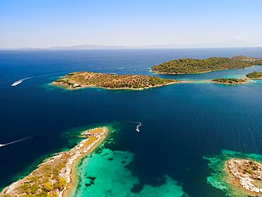 Mediterranean Greek landscape beach drone shot above Sithonia Chalkidiki peninsula, with small islands and clear waters.