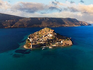 Aerial drone view of Spinalonga, deserted leper colony with fortifications, currently a tourist attraction, in Crete island.