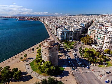 Thessaloniki, Greece aerial drone view of White Tower landmark with residential buildings at Leoforos Nikis calm seafront.