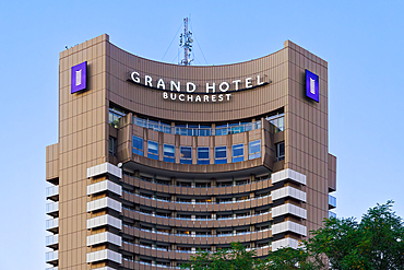 Low angle view of Grand Hotel Bucharest skyscraper with logo, under a clear blue sky, Bucharest, Romania, Europe