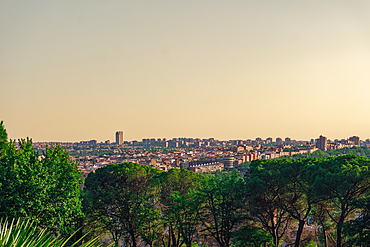 City skyline panoramic view with warm hues of the evening sky casting a golden glow on buildings, Madrid, Spain, Europe