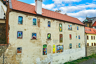 Vivid graffiti on the windows and wall of an old house with roof tiles, Bratislava, Slovakia, Europe