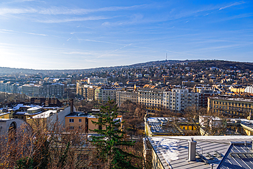 Panoramic landscape with hill houses in winter with melting snow on rooftops, Budapest, Hungary, Europe