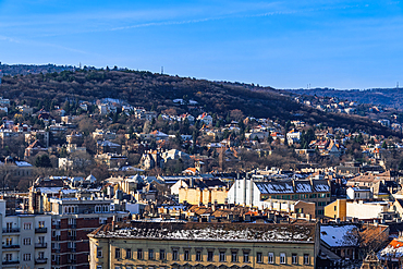 Panoramic landscape with hill houses in winter with melting snow on rooftops, Budapest, Hungary, Europe