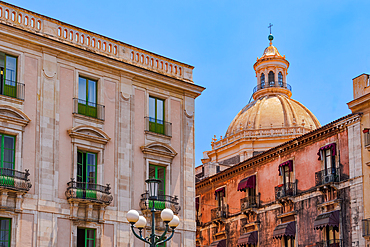 Abbey of St. Agatha cupola behind historic buildings with iron balconies in Catania, Sicily, Italy, Mediterranean, Europe