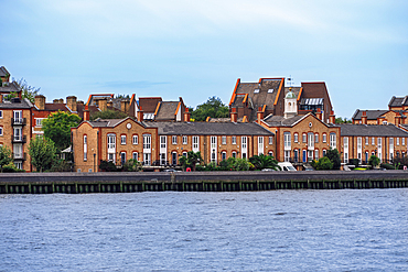 London, UK riverside view of terraced houses along the Thames river.