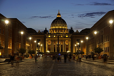 St. Peter's Cathedral night view with passing crowd, from Via della Conciliazione, Rome, Lazio, Italy, Europe