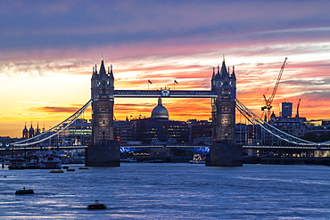 Tower Bridge, St. Paul's Cathedral and the City skyline over the River Thames at sunset, London, England, United Kingdom, Europe