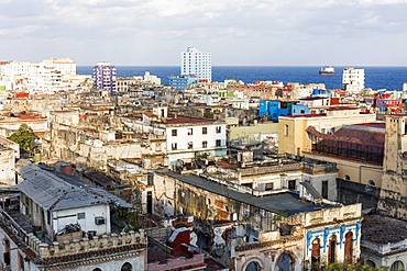 View over old building rooftops in Centro Habana, and Straits of Florida, Havana, Cuba, West Indies, Caribbean, Central America