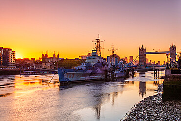 HMS Belfast and Tower Bridge at sunrise with a low tide on the River Thames, London, England, United Kingdom, Europe