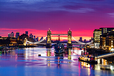 Tower Bridge and HMS Belfast reflecting in a still River Thames at sunset, London, England, United Kingdom, Europe