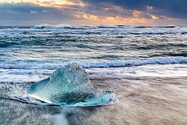 Iceberg from melting glacier on black sand beach near Jokulsarlon glacier lagoon, Vatnajokull National Park, Iceland, Polar Regions