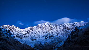 Clouds and stars at night over Annapurna, image taken from Base Camp in the Sanctuary, Himalayas, Nepal, Asia