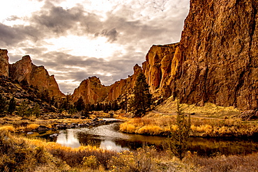 A river running through a valley with large rock formations on either side, Oregon, United States of America, North America