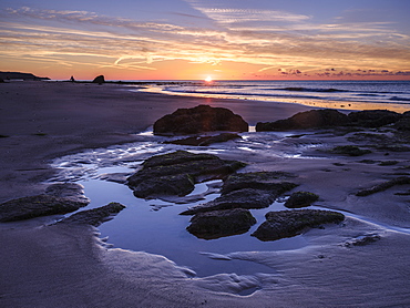 Sunrise on the shoreline with rocks and rock pools at Orcombe Point, Exmouth, Devon, England, United Kingdom, Europe