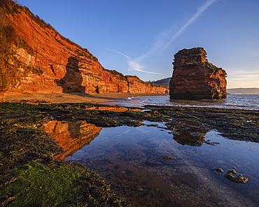 Dawn on the beach with one of the majestic sea stacks at Ladram Bay, Sidmouth, Devon, England, United Kingdom, Europe