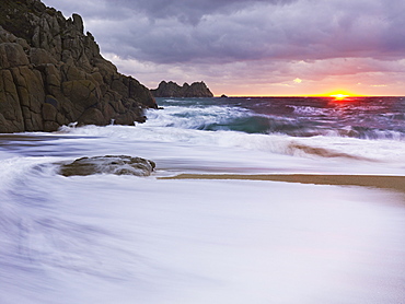 Early morning on the beach looking out towards Logan Rock at Porthcurno, Cornwall, England, United Kingdom, Europe