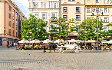 Horse and carrriage taxi in The Old town Square, UNESCO World Heritage Site, Krakow, Poland, Europe