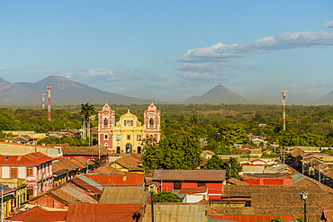 A view over the terracotta rooftops, of the colourful church of El Calvario, Leon, Nicaragua, Central America