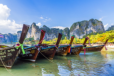 Long tail boats and karst scenery on Railay beach in Railay, Ao Nang, Krabi Province, Thailand, Southeast Asia, Asia