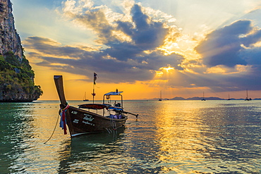 A long tail boat at sunset on Railay beach in Railay, Ao Nang, Krabi Province, Thailand, Southeast Asia, Asia