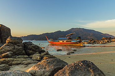 A long tail boat at dusk in Ko Lipe, Tarutao National Marine Park, Thailand, Southeast Asia, Asia