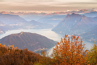 Iseo Lake, Monte Isola and Orobie Alps at sunset with fog in autumn season, Brescia Province, Lombardy, Italy, Europe