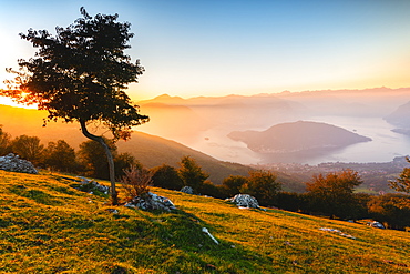 Iseo Lake and Monte Isola at sunset with fog in autumn season, Brescia Province, Lombardy, Italy, Europe