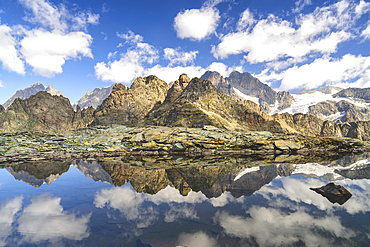 Reflection in Alpine lake in Valmalenco, Italian valley in Valtellina, Sondrio province in Lombardy district, Italy, Europe