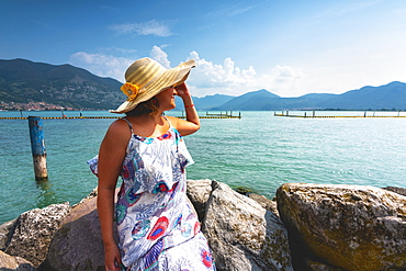 Woman admiring Lake Iseo, Clusane d'Iseo, Brescia province, Lombardy, Italy, Europe