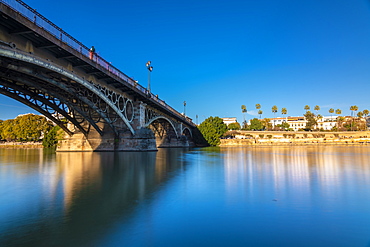 Long exposure of Puente de Triana on Guadalquivir River with Seville in the background, Seville, Andalucia, Spain, Europe