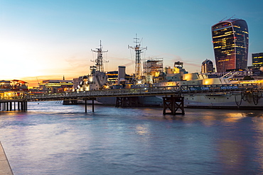 Skyline of the City of London at sunset with HMS Belfast in the foreground, London, England, United Kingdom, Europe