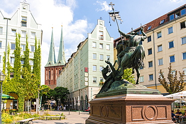 Nikolaiviertel (Nicholas Quarter) at sunset near Alexander Platz with statue of St. George Slaying The Dragon and church spires, Berlin, Germany, Europe