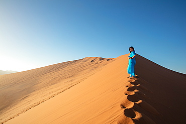 Model climbing Dune 13, Sossusvlei, Namibia, Africa