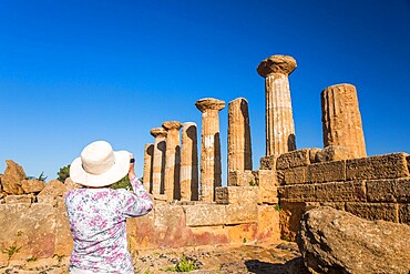 Visitor photographing the Temple of Heracles (Temple of Hercules), UNESCO World Heritage Site, Valley of the Temples, Agrigento, Sicily, Italy, Mediterranean, Europe