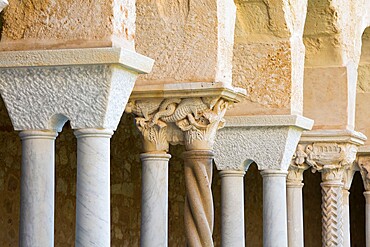 Row of columns and finely carved capitals in cloister of the Arab-Norman cathedral, UNESCO World Heritage Site, Cefalu, Palermo, Sicily, Italy, Mediterranean, Europe