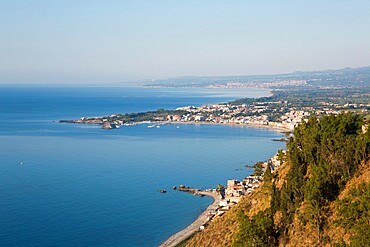 View from Piazza IX Aprile over the Bay of Naxos to distant Giardini-Naxos, early morning, Taormina, Messina, Sicily, Italy, Mediterranean, Europe