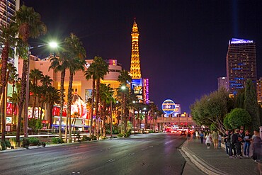 View along The Strip by night, illuminated Eiffel Tower at the Paris Hotel and Casino prominent, Las Vegas, Nevada, United States of America, North America