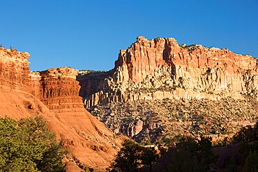 Sandstone cliffs of the Waterpocket Fold towering above Scenic Drive, sunset, Fruita, Capitol Reef National Park, Utah, United States of America, North America