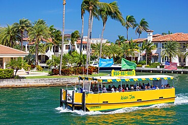 Colourful water taxi cruising along the New River, Las Olas Isles, Fort Lauderdale, Florida, United States of America, North America