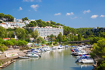 View inland along the tranquil Algendar River, boats moored along banks, Cala Galdana, Menorca, Balearic Islands, Spain, Mediterranean, Europe