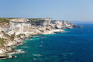 View along rugged limestone cliffs to Capo Pertusato and the distant coast of Sardinia, Bonifacio, Corse-du-Sud, Corsica, France, Mediterranean, Europe