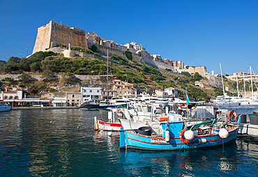 View across harbour to the historic citadel, colourful fishing boats in foreground, Bonifacio, Corse-du-Sud, Corsica, France, Mediterranean, Europe