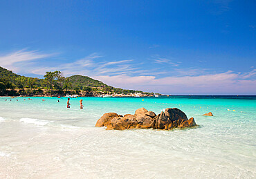 Tourists relaxing in shallow turquoise water off the Plage de Verghia, Coti-Chiavari, Ajaccio, Corse-du-Sud, Corsica, France, Mediterranean, Europe