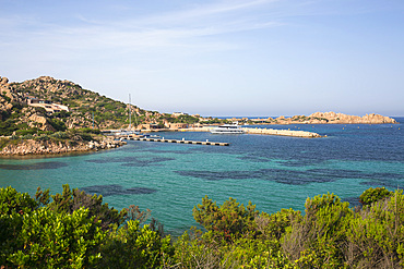 View over calm turquoise water to Porto Massimo and the rocky headland of Punta Lunga, La Maddalena Island, La Maddalena Archipelago National Park, Sassari, Sardinia, Italy, Mediterranean, Europe