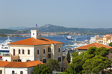 View across tiled rooftops to distant Palau, the Palazzo dell'Ammiragliato (Admiralty), prominent in foreground, La Maddalena, La Maddalena Island, La Maddalena Archipelago National Park, Sassari, Sardinia, Italy, Mediterranean, Europe