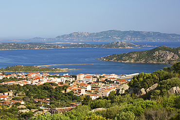 View from rocky hillside over town rooftops to the islands of Santo Stefano and Caprera, La Maddalena, La Maddalena Island, La Maddalena Archipelago National Park, Sassari, Sardinia, Italy, Mediterranean, Europe