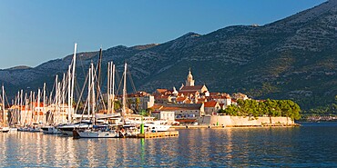 Panoramic view across marina to the Old Town at sunrise, Korcula Town, Korcula, Dubrovnik-Neretva, Dalmatia, Croatia, Europe