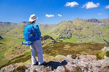 Hiker on summit of Lingmoor Fell, the Langdale Pikes beyond, Great Langdale, Lake District National Park, UNESCO World Heritage Site, Cumbria, England, United Kingdom, Europe