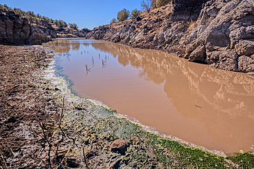 View of the lake created by the historic Bainbridge Steel Dam near Ash Fork Arizona in the Kaibab National Forest. It was originally constructed in the late 1800s and is now a historic landmark that is open to the public.